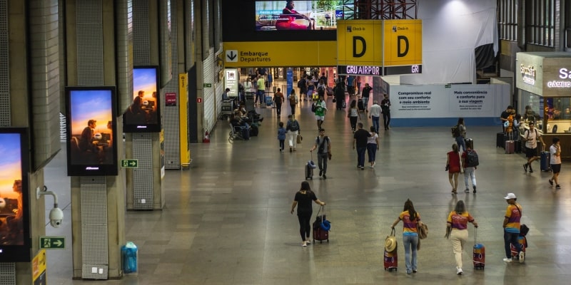 Pessoas no saguão do aeroporto de Guarulhos. Imagem para ilustrar a matéria sobre o programa Voa Brasil.